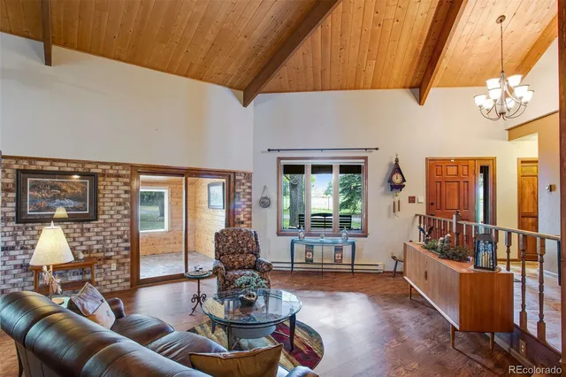 a dining room with furniture and a floor to ceiling window