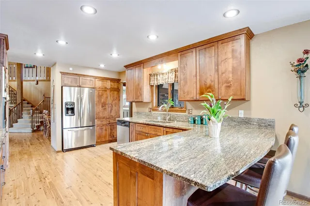 a bedroom with a bed and a dresser next to a window