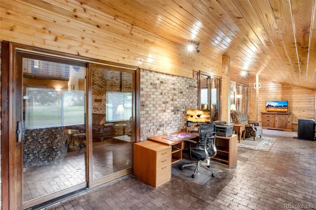 a view of a patio with a table and chairs under an umbrella