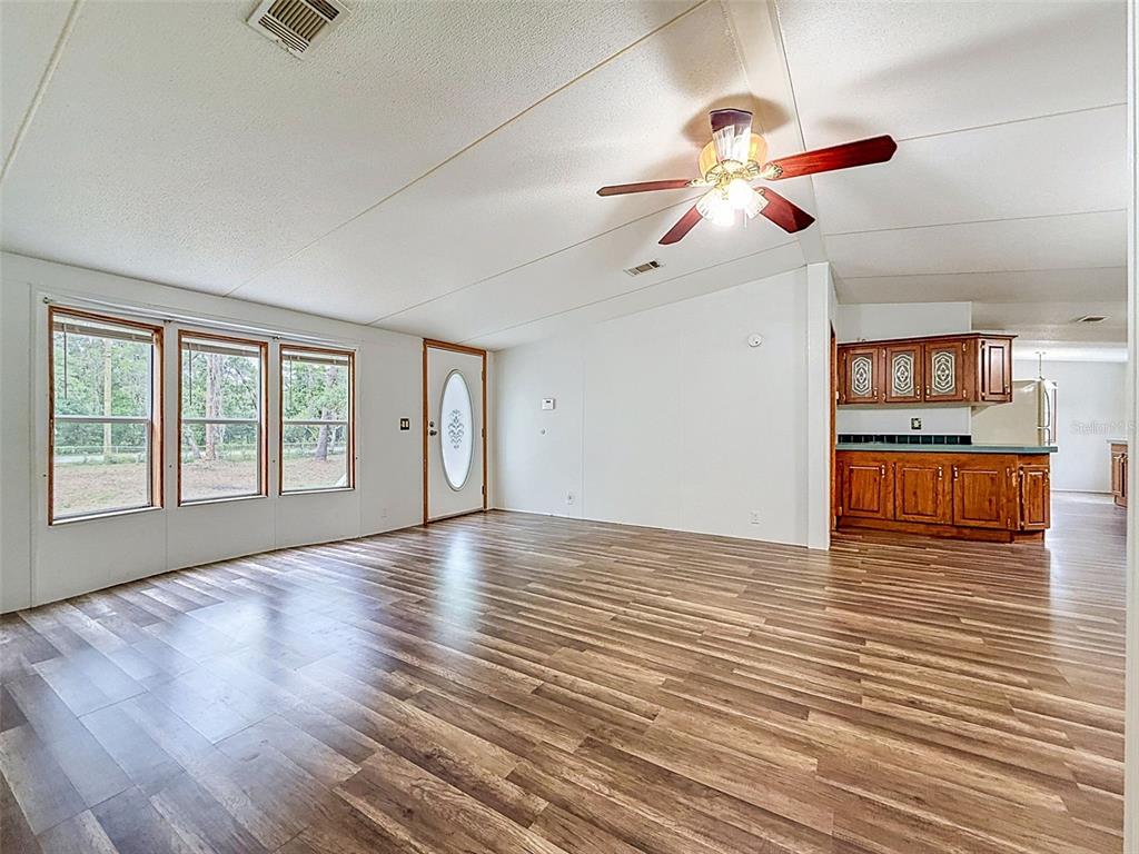 1819 Sinclair Hills Road Lutz, FL 33549 - Photo 18 of 60 a view of an empty room with window and wooden floor