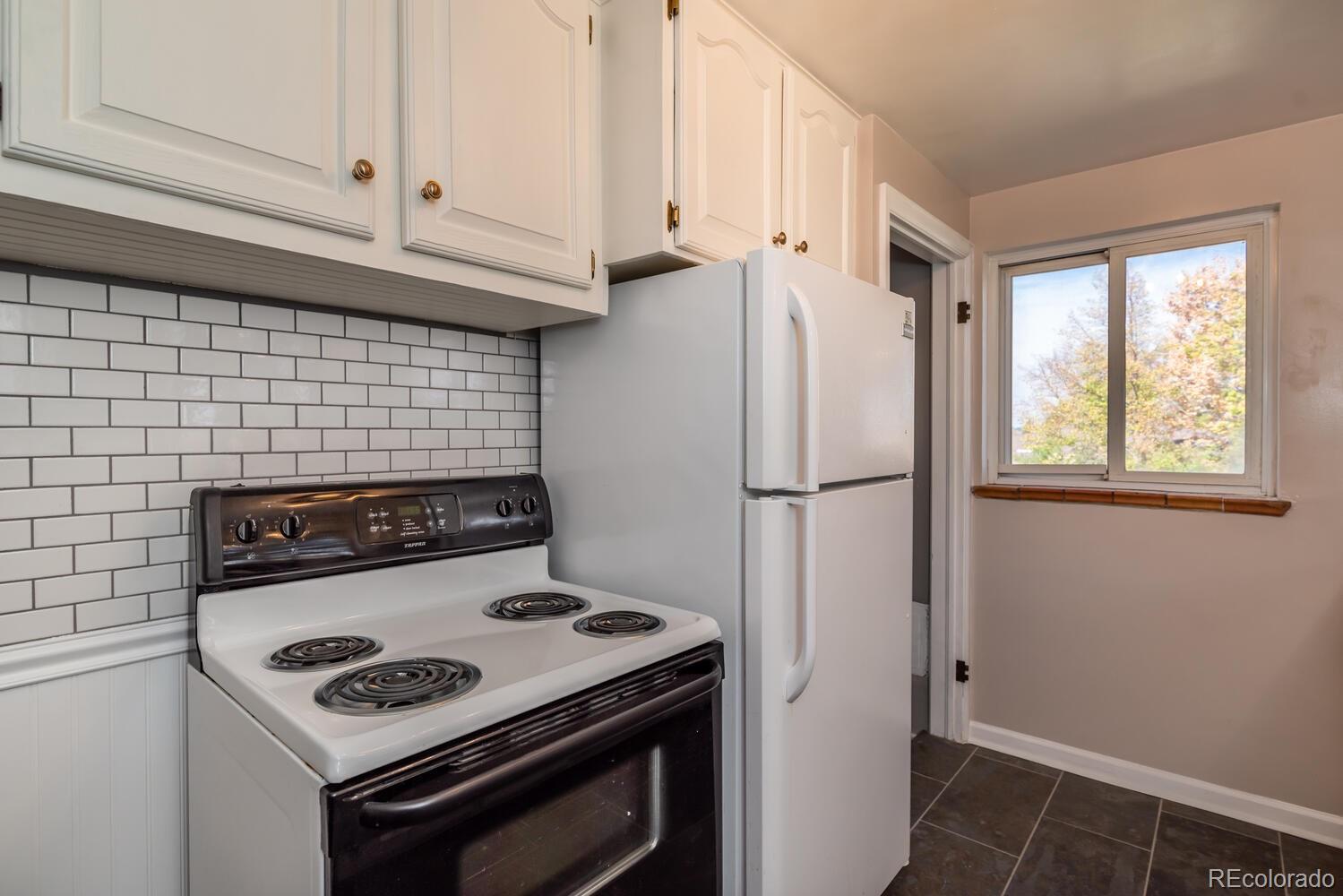 4095 Pierce Street Wheat Ridge, CO 80033 - Photo 8 of 29 a stove top oven sitting inside of a kitchen