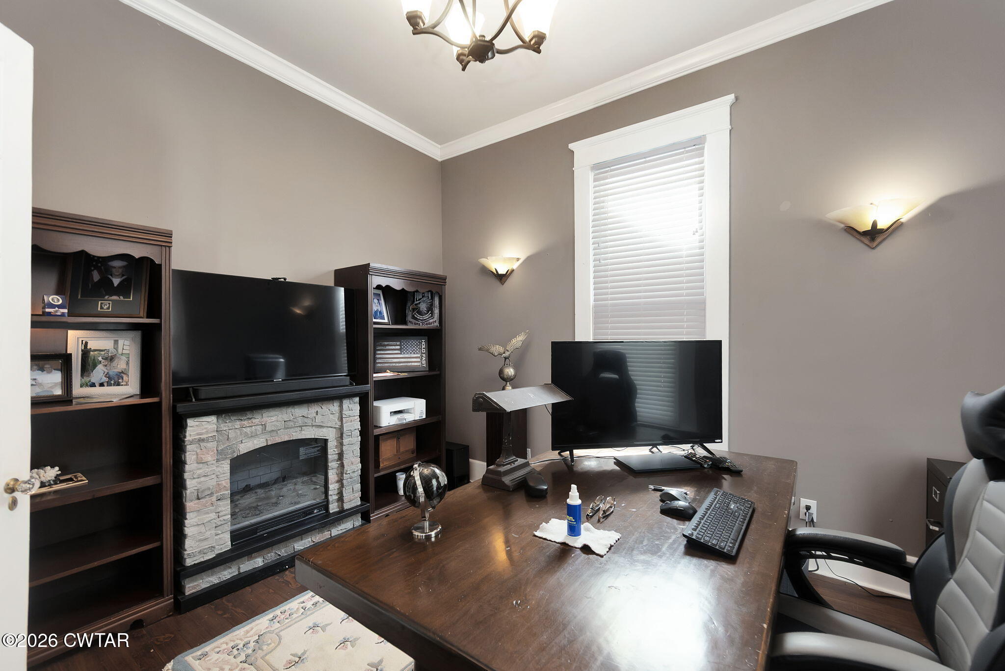 554 East Main Street Jackson, TN 38301 - Photo 7 of 60 a work room with furniture a flat screen tv and a fireplace