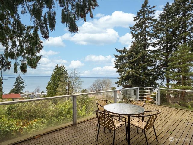 a balcony with wooden floor and city view