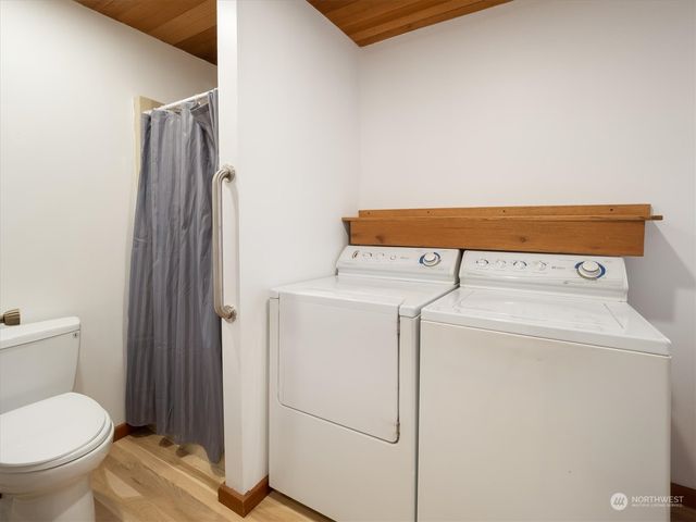 a bed sitting in a spacious bedroom next to a window