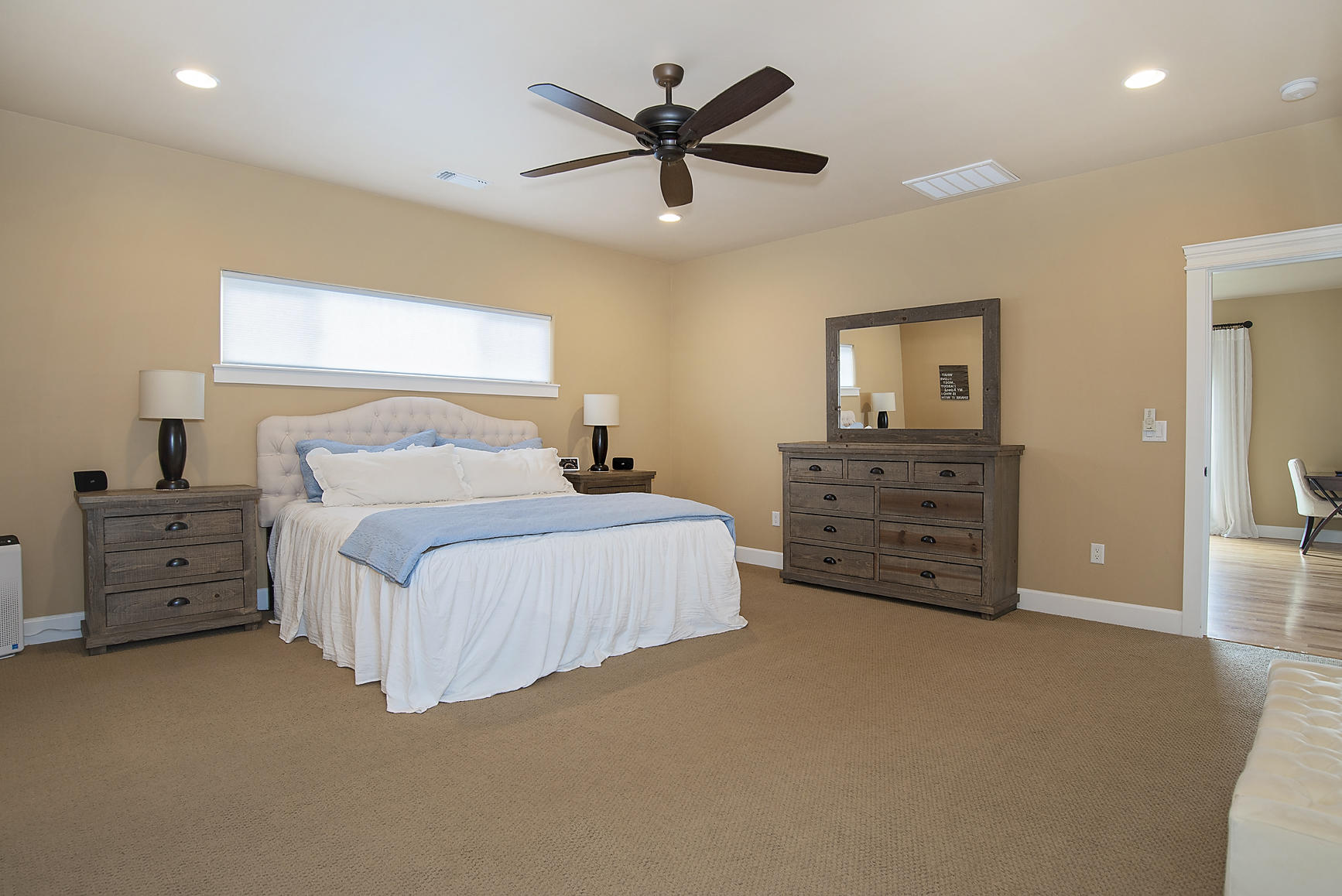 1360 Poppy Ridge Drive Eagle Point, OR 97524 - Photo 13 of 34 a spacious bedroom with a bed and a chandelier