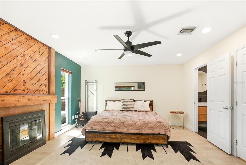4606 Buckeye Road Tampa, FL 33624 - Photo 20 of 39 a bedroom with a bed and a fireplace