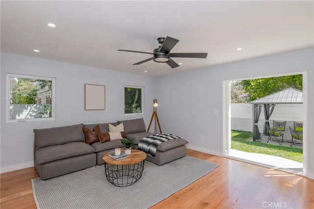 a living room with furniture and a floor to ceiling window