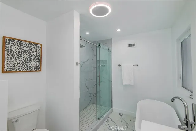 a bathroom with a shower and a sink