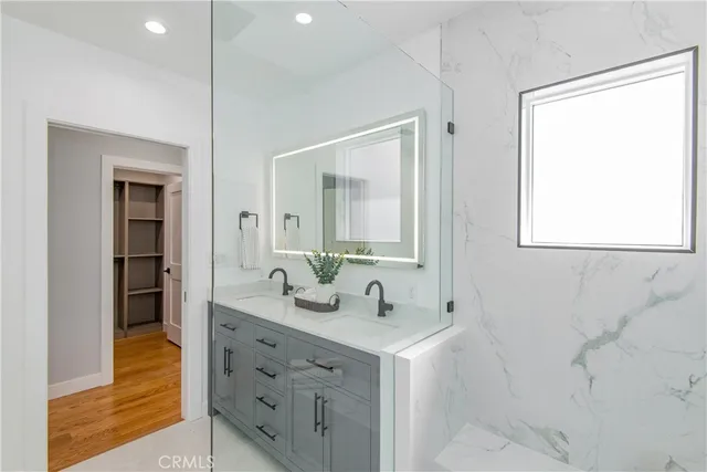 a bathroom with a double vanity sink and a mirror