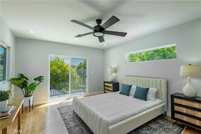 a bedroom with a bed and a potted plant