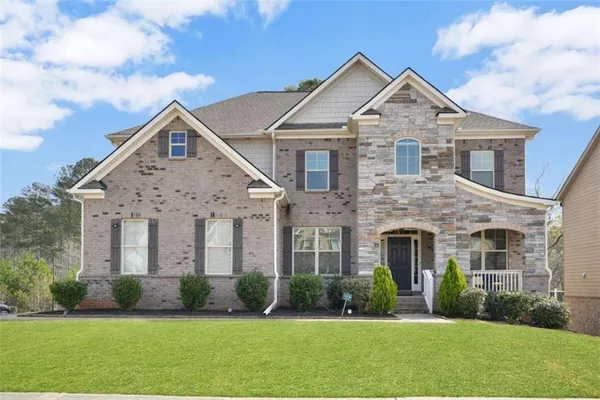 a front view of a house with a yard