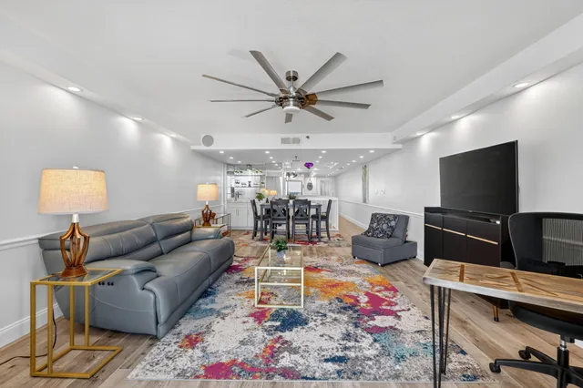 a hallway with wooden floor and staircase