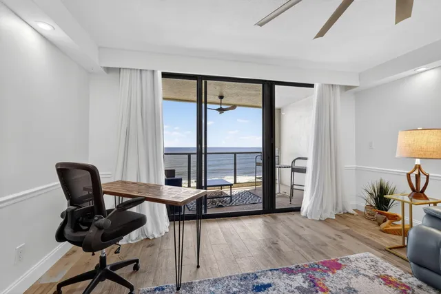 a spacious bedroom with a bed and a chandelier