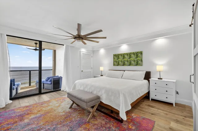 a bedroom with a large bed and a chandelier