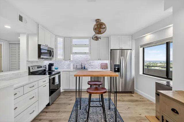 a living room with furniture and kitchen view