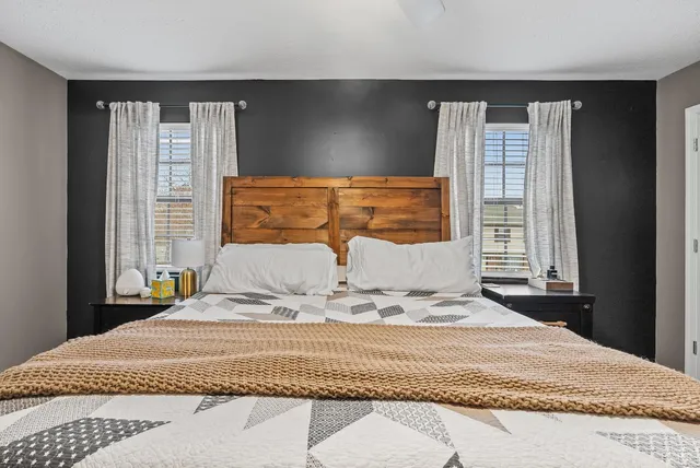 a bedroom with a large bed and a window