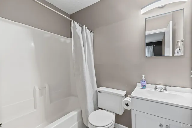 a white toilet sitting next to a bathroom sink