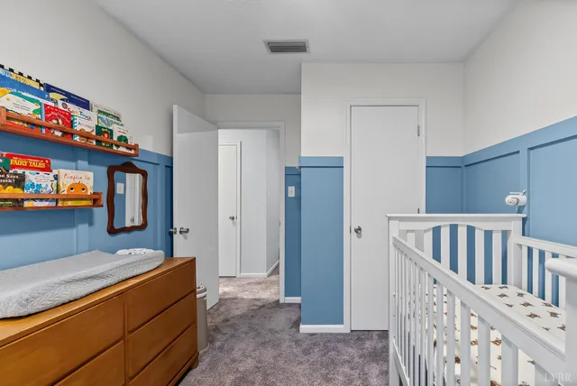a bedroom with furniture and a baby crib