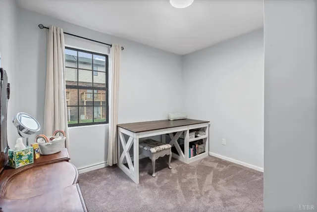 a living room with a bed furniture and a window