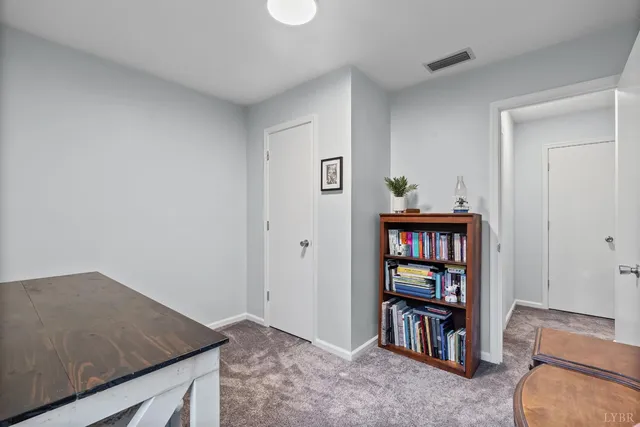 a view of an empty room and workspace