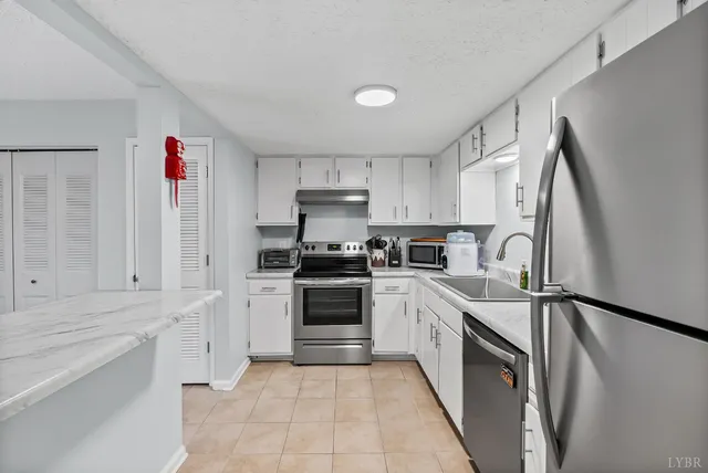 a kitchen with stainless steel appliances granite countertop a sink and cabinets