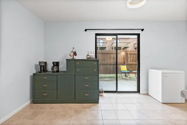 a room with a dresser and a window