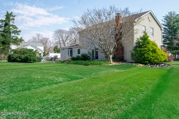 a view of a house with a big yard and garden