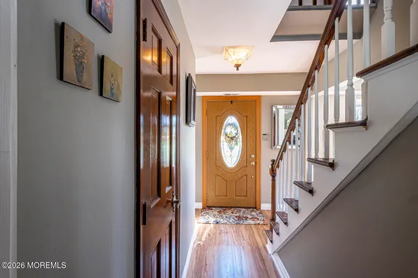 a view of a hallway with wooden floor