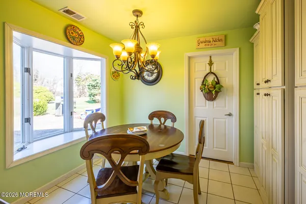 a dining room with furniture and a window