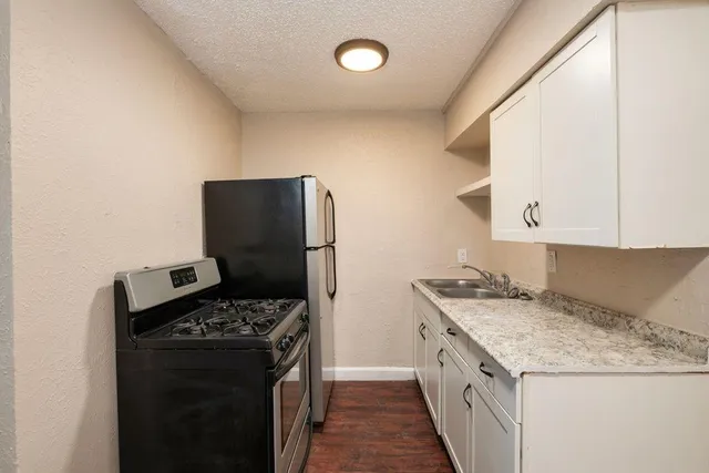 a kitchen with a stove and a refrigerator