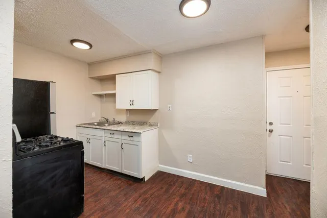 a view of an empty room and wooden floor