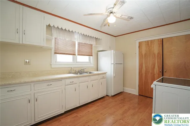 a kitchen with sink cabinets and window