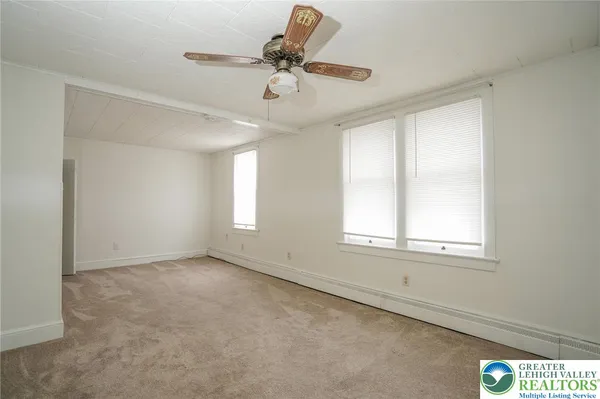 a view of an empty room with a window