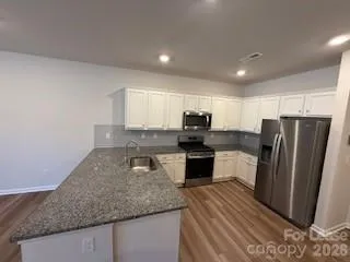 a kitchen with refrigerator a stove a sink and a counter top space