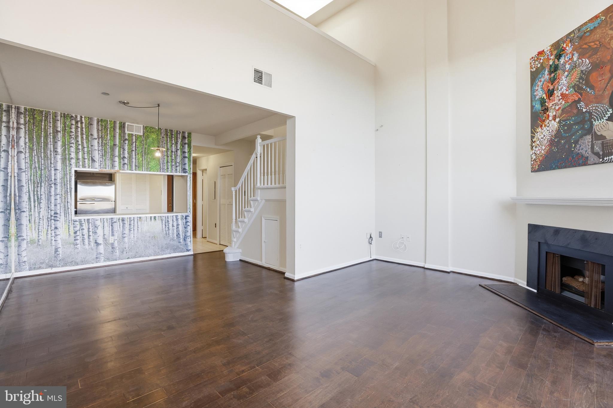 1301 North Courthouse Road, Unit 1804 Arlington, VA 22201 - Photo 14 of 29 an empty room with wooden floor fireplace and cabinet