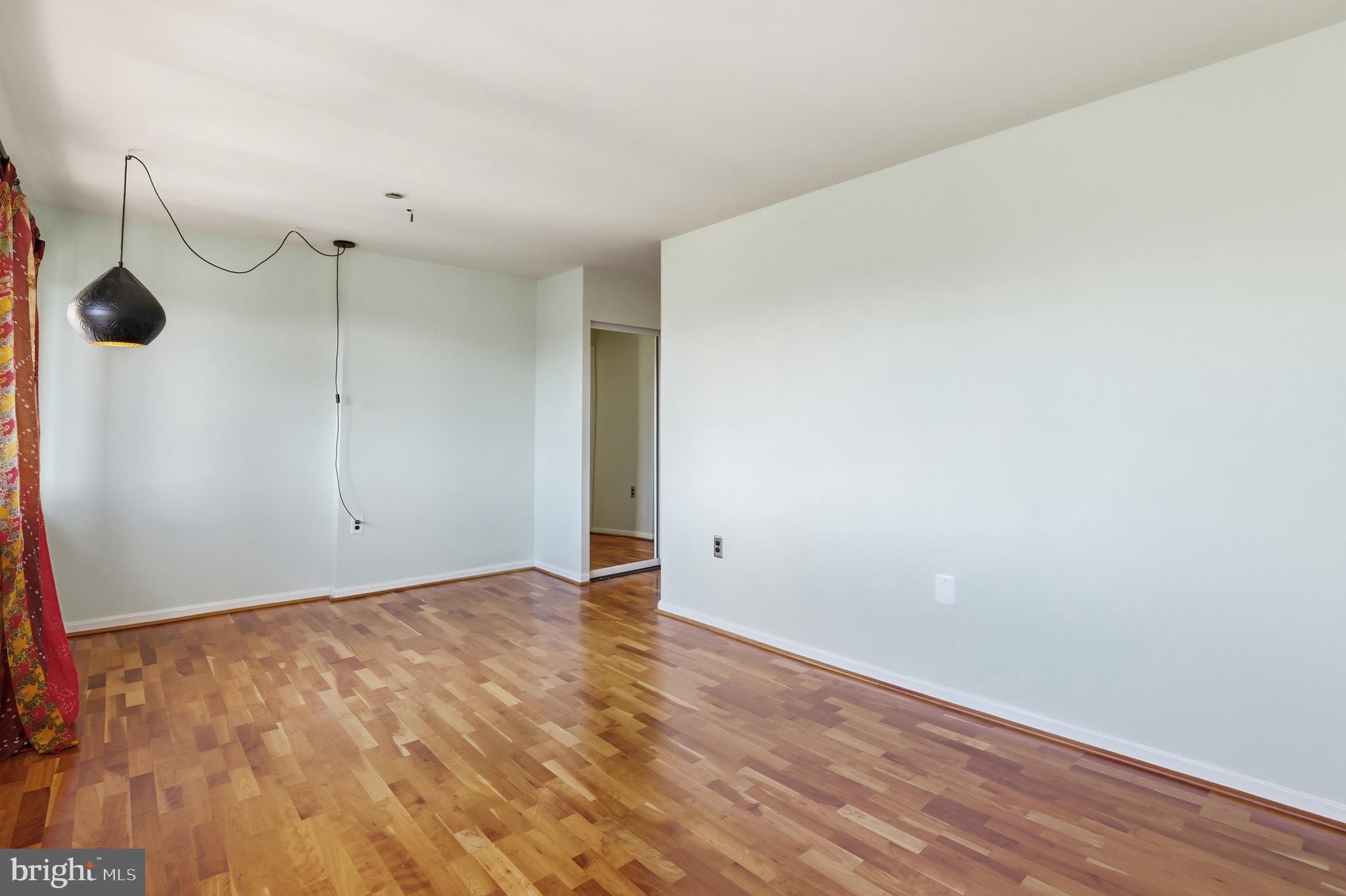 1301 North Courthouse Road, Unit 1804 Arlington, VA 22201 - Photo 20 of 29 a view of an empty room with wooden floor