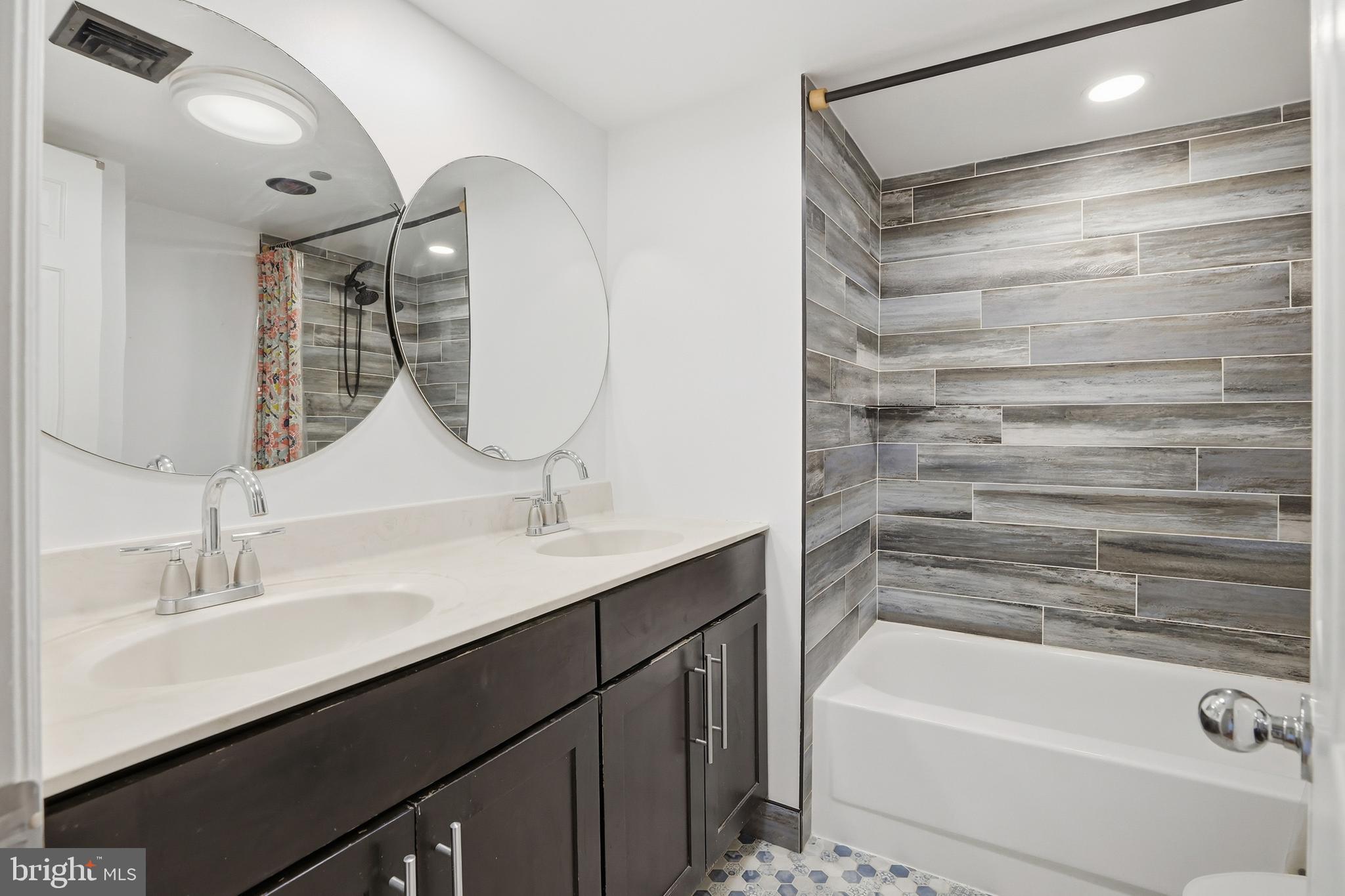 1301 North Courthouse Road, Unit 1804 Arlington, VA 22201 - Photo 24 of 29 a bathroom with a tub sink and mirror