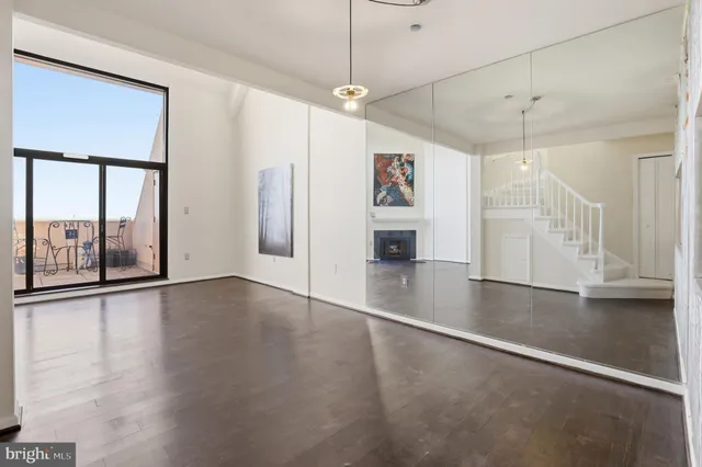 a view interior of a house with wooden floor fireplace and windows