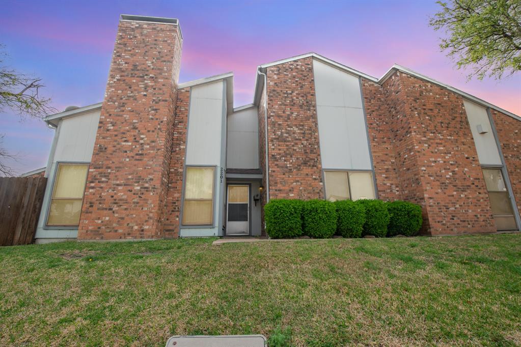 a brick building with a yard