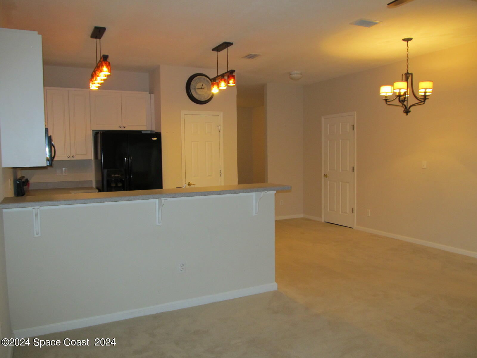 2795 Reston Street, Unit 104 Melbourne, FL 32935 - Photo 8 of 36 a view of a livingroom with a chandelier furniture and fireplace