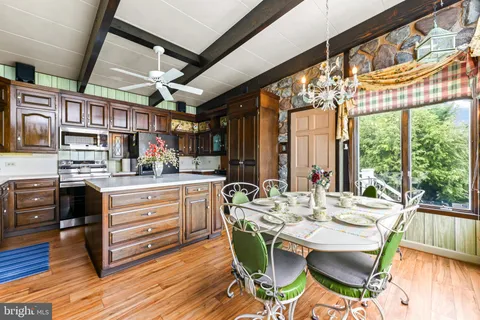 a kitchen with a sink a stove and cabinets