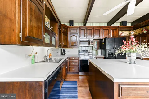 a kitchen with a stove a sink and a refrigerator