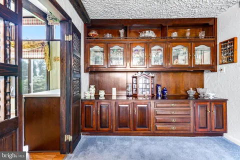 a view of entryway and hall with a fireplace