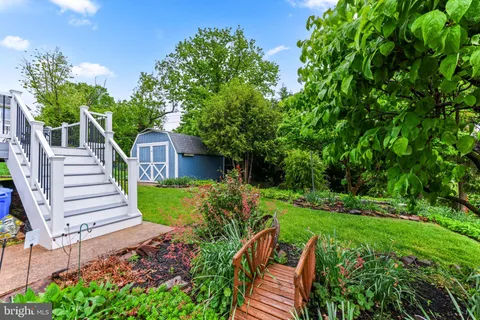 a view of an house with roof deck and garden