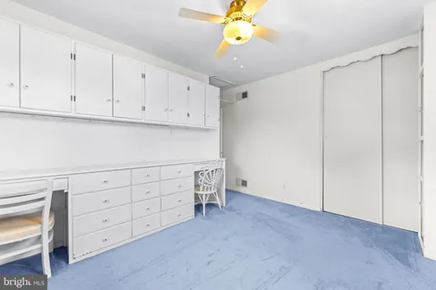 a bed room with a bed and a book shelf