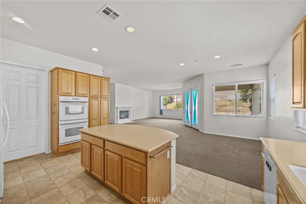 1140 Lantana Road Beaumont, CA 92223 - Photo 12 of 30 a view of an empty room with a window and a kitchen