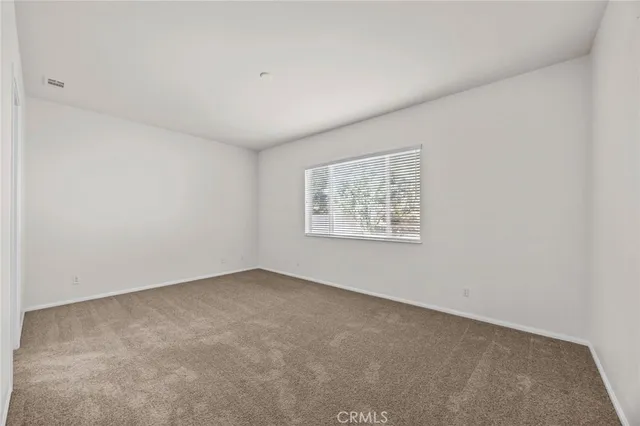 an empty room with a empty space and window