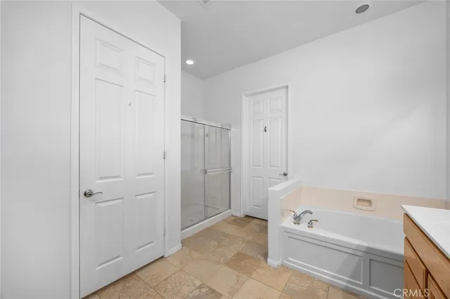 a bathroom with a tub a toilet and a shower