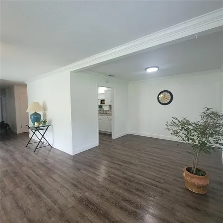 a view of an empty room and wooden floor