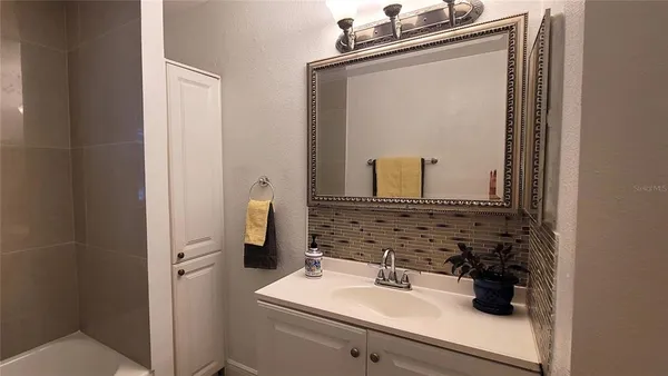 a bathroom with a sink vanity and a mirror